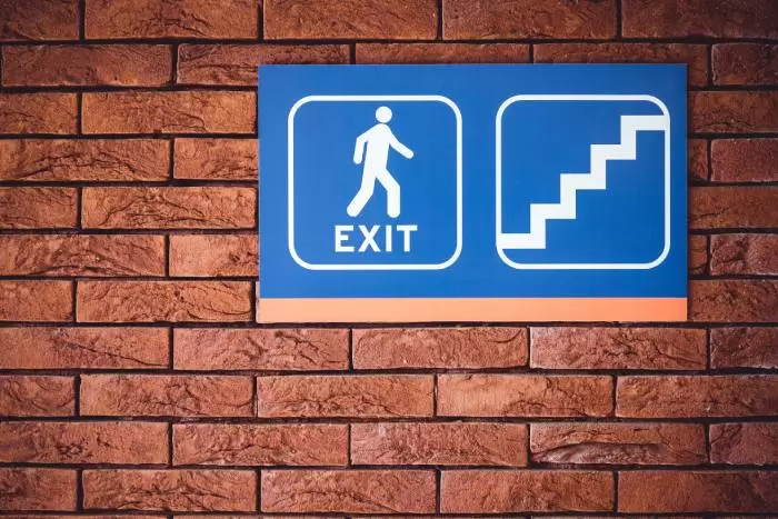 Exit Signage In Stairwell on a brick wall